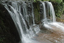 Waterfalls cascading over layered beds of sandstone, Lambir Hills National Park, Malaysia