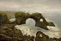 Natural bridge along coast, southwest coast of Iceland