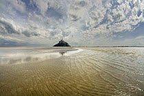 Mont Saint-Michel with waves in surrounding bay, Normandy, France