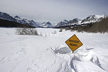 Road sign buried in snow, Many Glacier, Glacier National Park, Montana