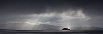 Sunrays filtering through clouds, Fivemile Island, Alaska