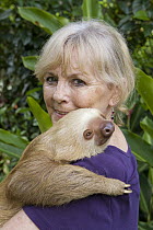 Hoffmann's Two-toed Sloth (Choloepus hoffmanni) held by sanctuary owner Judy Avey-Arroyo, Aviarios Sloth Sanctuary, Costa Rica