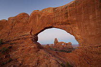 Turret Arch as seen through the North Window Arch at sunrise, Arches National Park, Utah