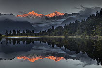 Sunset reflection of Lake Matheson with Mount Tasman and Mount Cook, Westland National Park, New Zealand