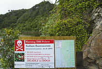 Warning sign warning of presence of poison to hikers and pet owners, Karamea, South Island, New Zealand