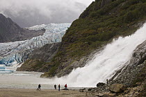 Nugget Falls and Mendenhall Glacier in background with tourists, Tongass National Forest, Juneau, Alaska