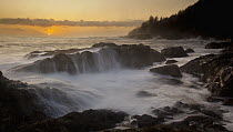 Rocky shoreline and waves at sunset, Vancouver Island near Cape Scott, Canada