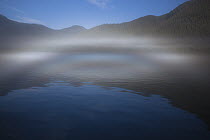 Ocean fog lifting off the water at the mouth of Kynoch Inlet, British Columbia, Canada