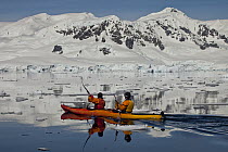 Tourists sea kayaking near Enterprise Island, Gerlache Strait, Antarctic Peninsula, Antarctica