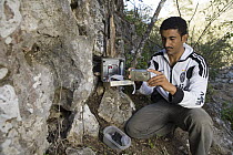 Arabian Leopard (Panthera pardus nimr) researcher Waleed Al'Rail checking camera trap, Hawf Protected Area, Yemen