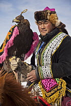 Golden Eagle (Aquila chrysaetos) used for hunting, with Kazak handler competing at winter festival, Mongolia