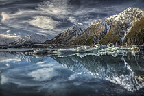 Reflection of clouds, peaks and icebergs in lake, Tasman Glacier, Mount Cook National Park, New Zealand