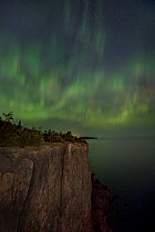 Aurora borealis over lake shore, Lake Superior, Minnesota