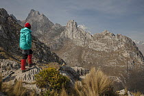 Trekker and limestone ridges with peaks from 4700 meter Cacananpunta Pass, Cordillera Huayhuash, Andes, Peru