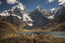 Trekkers camp near Carhuacocha Lake under Yerupaja peak, Cordillera Huayhuash, Andes, Peru