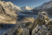 Snow-covered boulders on Ball Pass at dawn with Hochstetter Glacier and Tasman Glacier below, Mount Cook National Park, Canterbury, New Zealand