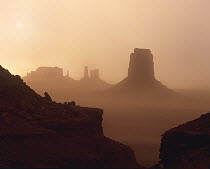 Sandstorm enshrouding mittens, Monument Valley, Arizona