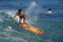 Woman surfer catching a wave