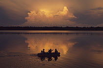 Sunset with people in canoe, Laguna Zancudo Cocha, Ecuador