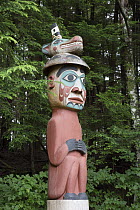 Man Wearing Bear Hat Totem carved by the Tlingit people acts as grave marker, Totem Bight State Historical Park, Ketchikan, Alaska