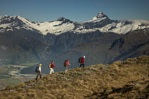 Trekkers on Buchanan Peaks with Mount Aspiring behind, Lake Wanaka, New Zealand