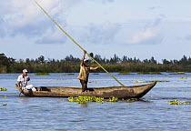 Men in dugout canoe on the Pangalanes Canal, Madagascar
