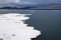 Floating ice with mountain range in distance, Wrangel Island, Russia