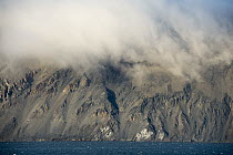 Clouds hugging the tops of shoreline cliffs, Wrangel Island, Russia