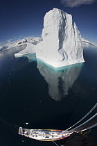Giant iceberg and sailboat seen from the crow's nest, Gerlache Strait, Antarctic Peninsula, Antarctica