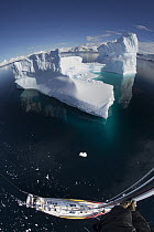 Giant iceberg and sailboat seen from the crow's nest, Gerlache Strait, Antarctic Peninsula, Antarctica