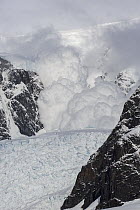 Avalanche rolling down mountain, Paradise Bay, Antarctic Peninsula, Antarctica