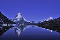 Matterhorn reflected in the Riffelsee Lake under a full moon, Switzerland