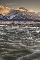Fast flowing stream through Tasman River flats at dawn, Mount Cook National Park, New Zealand