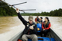 Sunda Clouded Leopard (Neofelis diardi) researcher Andrew Hearn radio tracking from boat with other biologists, Kinabatangan River, Sabah, Borneo, Malaysia