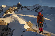 Climber near Pioneer Hut with Douglas Peak and Fox Glacier, Westland Tai Poutini National Park, New Zealand