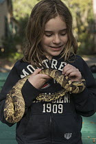 Louisiana Pinesnake (Pituophis ruthveni) held by girl, Orianne Indigo Snake Preserve, Georgia