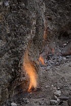 Smokeless fires dance where natural gas seeps from cracks in limestone rocks, Tanjung Api National Park, Ampana, Indonesia