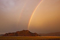 Double rainbow over mountain at sunset, Namib Desert, Namibia
