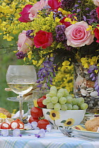 Rose (Rosa sp) flowers with wine and fruit