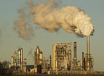 Oil refinery at sunrise spewing gas effluence out of smoke stacks, Anacortes, Washington