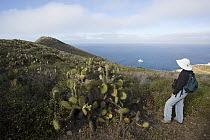 Tourist near cactus on island, Coronado Islands, Baja California, Mexico