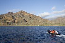 Tourists in zodiac approaching coastline, Cedros Island, Baja California, Mexico