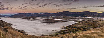 Alpenglow amd fog over lake, Lake Hayes, Arrowtown, Otago, New Zealand