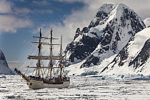 Tourist ship Europa in heavy pack ice beneath Mount Scott, Penola Strait, Antarctic Peninsula, Antarctica