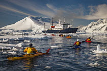 Kayakers paddling back to cruise ship Polar Pioneer, Lemaire Channel, Antarctic Peninsula, Antarctica