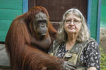 Orangutan (Pongo pygmaeus) primatologist, Dr. Birute Mary Galdikas, and dominant female, Camp Leakey, Tanjung Puting National Park, Central Kalimantan, Borneo, Indonesia