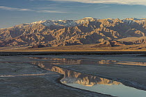 Mountain range reflected in water, Cottonball Basin, Death Valley National Park, California