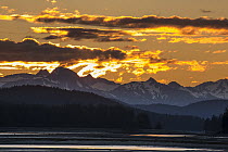 Sun setting behind mountains, Lynn Canal, Juneau, Alaska