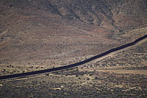 Border wall seperating Mexico and United States, Blue Angels Peak, Sierra de Juarez, Colorado Desert, Sonoran Desert, California