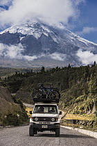 Car carrying bikes near volcano, Cotopaxi Volcano, Cotopaxi National Park, Andes, Ecuador